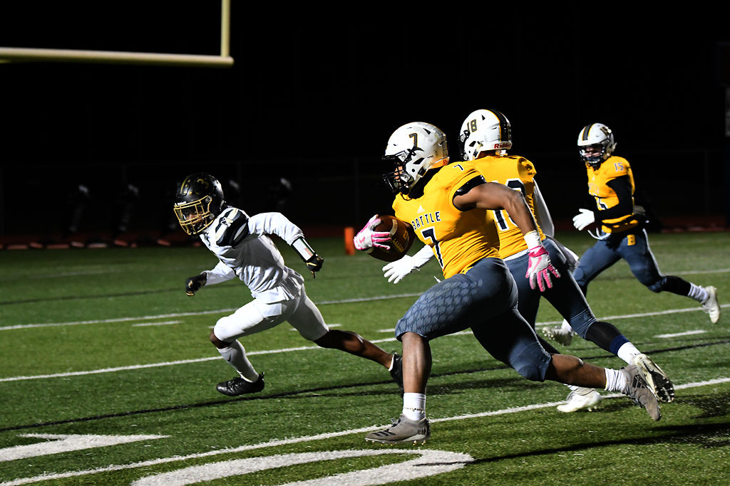 Darren Jordan runs toward the end zone while Khaliq Thomas defends